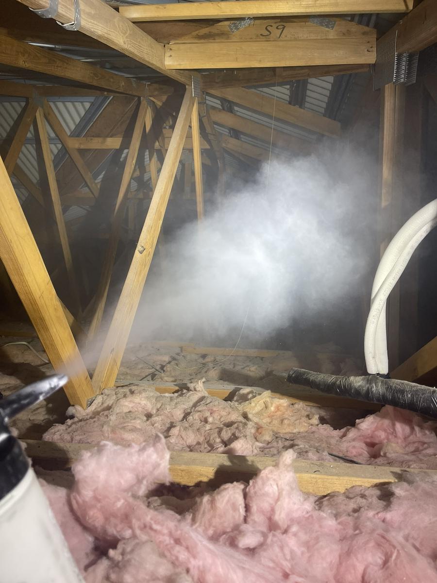 Pest treatment being applied inside a roof void